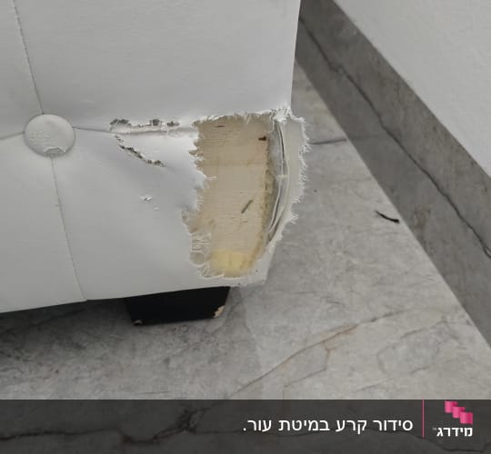 פינת ספה עם קרע בחיפוי הלבן